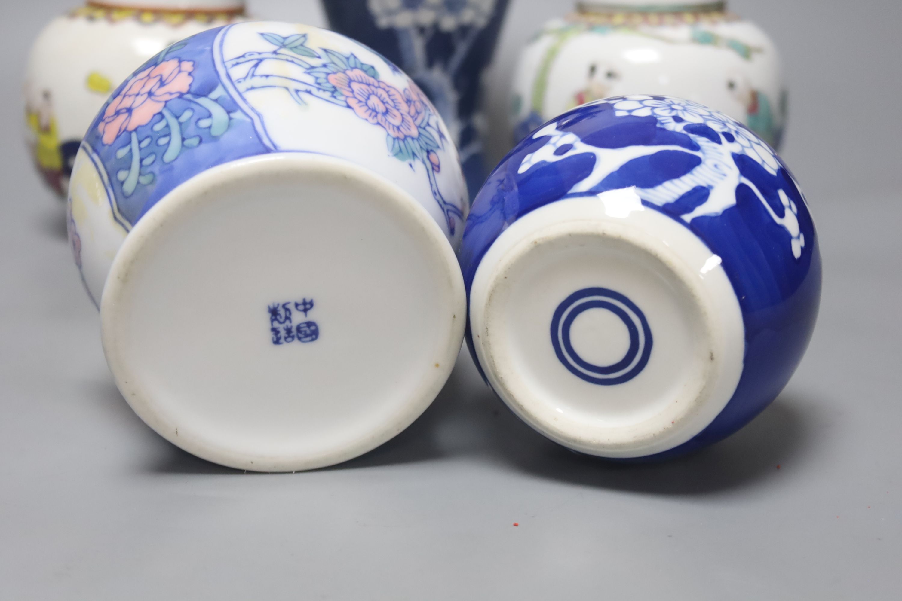 A Chinese blue and white vase and cover, a pair of famille rose jars and covers and two other jars and covers, tallest 27cm